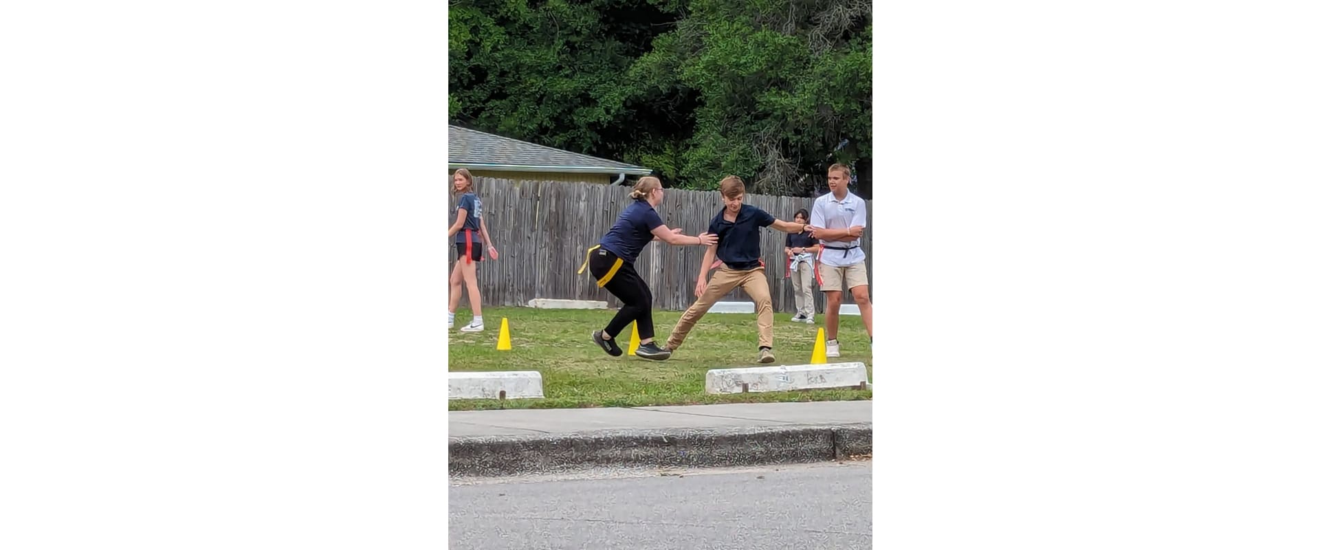 A group of people playing frisbee golf on the grass.