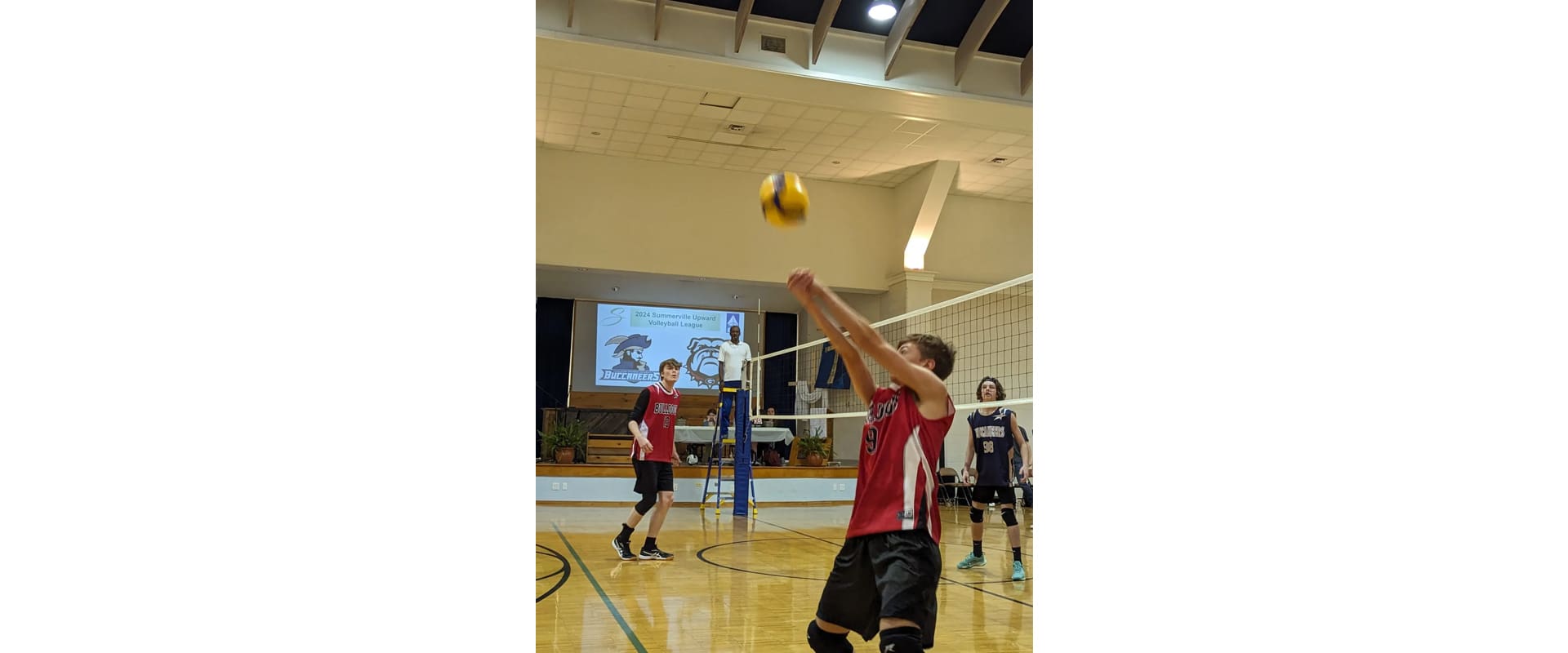 A man hitting a volleyball with a rope.