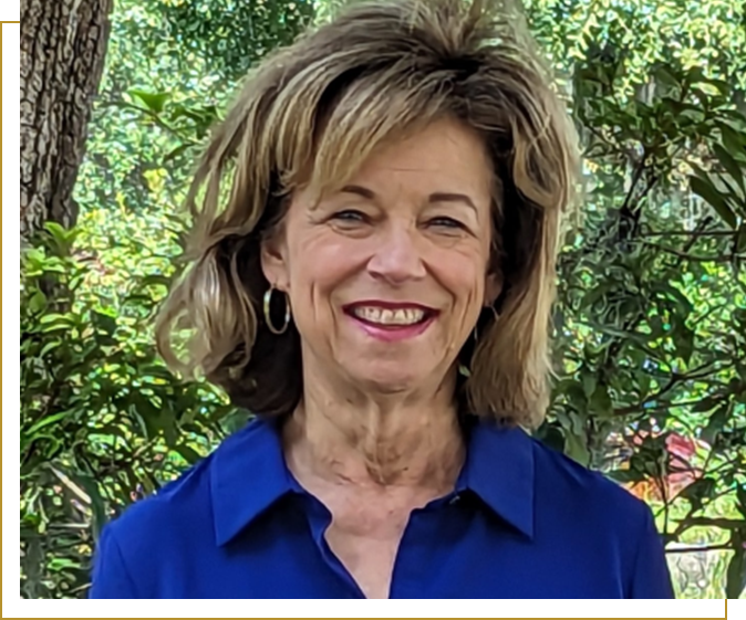 A woman with long hair and wearing blue shirt.