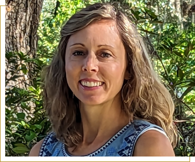 A woman with long hair is smiling for the camera.