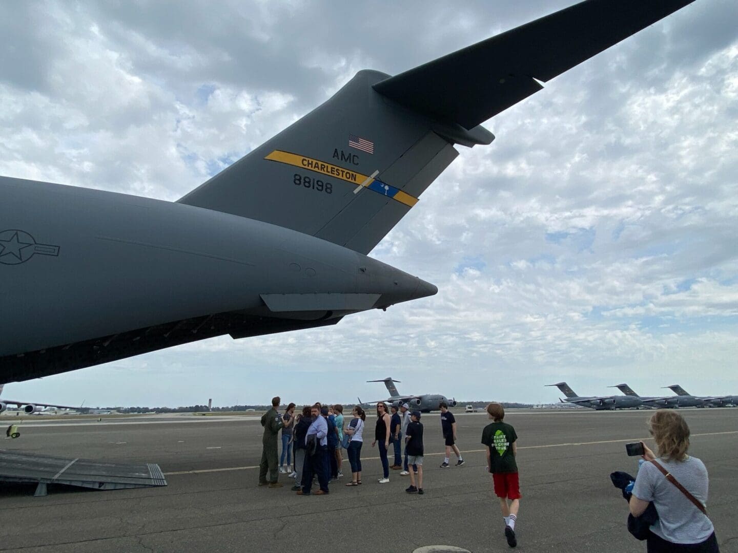 A group of people standing around an airplane.