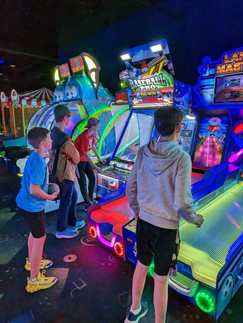 A group of people standing around playing video games.