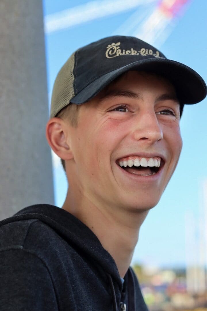 A man with a hat and smiling.