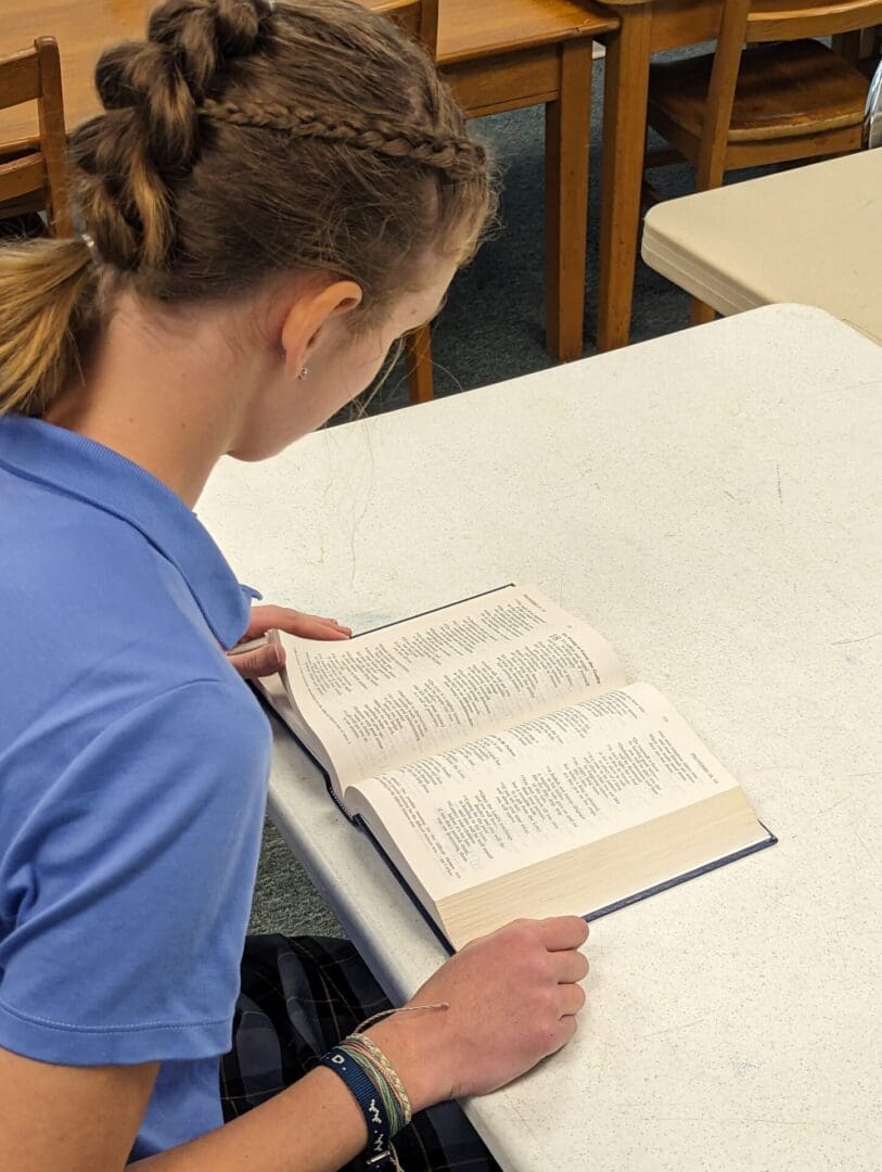 A woman reading a book at the table