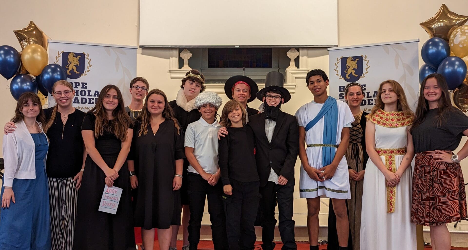 A group of people standing in front of a fireplace.