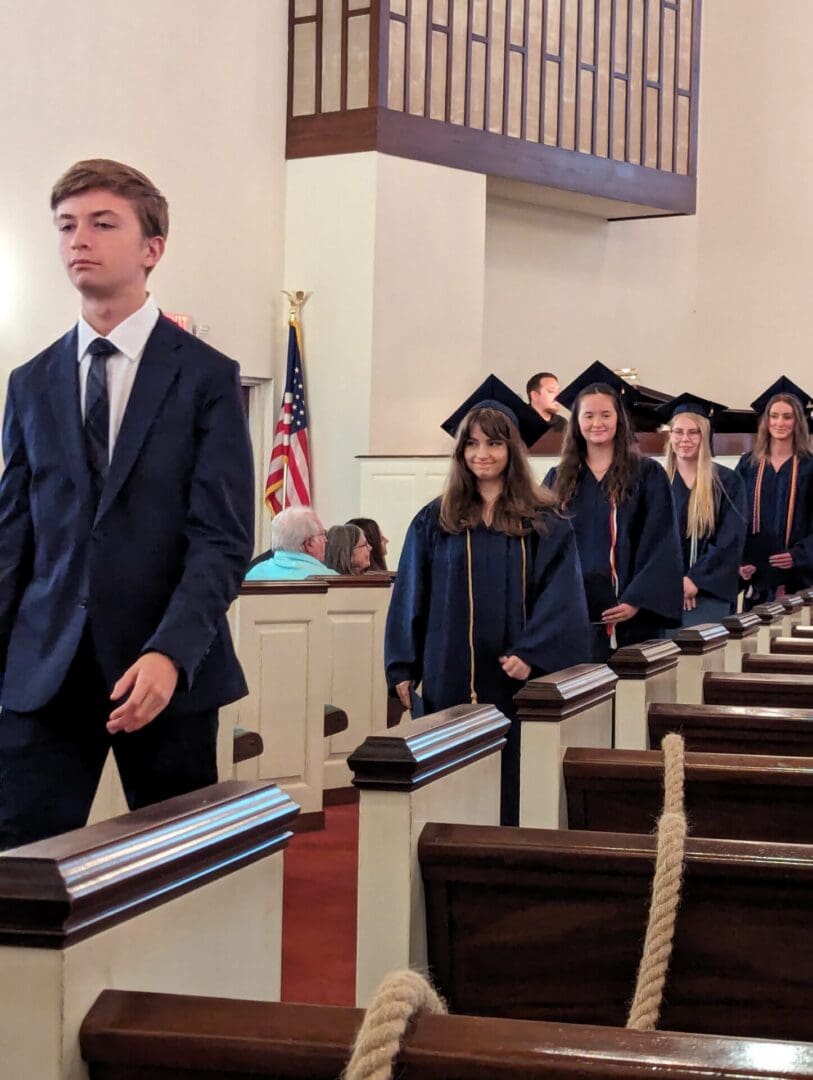 A group of people in graduation attire standing next to each other.