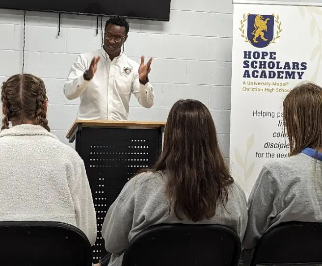 A man is giving a lecture to students.